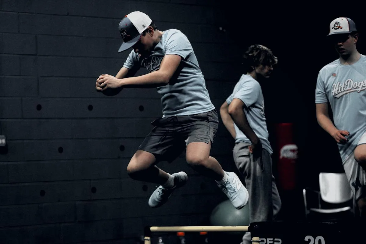 A GPS athlete performing a hurdle jump into a plyometric box during a training session
